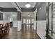 Open-concept living room with hardwood floors, white trim, and gray accent walls at 1698 Little Fox Ln, Dacula, GA 30019