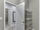 Spacious walk-in closet with wire shelving and a door leading to more storage space at 1698 Little Fox Ln, Dacula, GA 30019