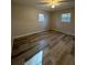 Bedroom featuring two windows for natural light and wood-look flooring at 4510 Burks Rd, Forest Park, GA 30297