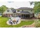Expansive backyard featuring a patio, screened-in porch, lush lawn, and mature trees for outdoor enjoyment at 5581 Stapleton Dr, Dunwoody, GA 30338
