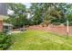 Lush backyard featuring a seating area, a grassy area, and beautiful landscaping, creating a serene outdoor space at 5581 Stapleton Dr, Dunwoody, GA 30338