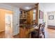 Cozy in-home bar with dark wood cabinets, granite countertop, and seating for two at 5581 Stapleton Dr, Dunwoody, GA 30338