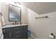 Bathroom with gray vanity, marble countertop, and black hardware at 5581 Stapleton Dr, Dunwoody, GA 30338