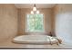 Bathroom with a large soaking tub and a garden view at 5581 Stapleton Dr, Dunwoody, GA 30338