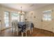 Cozy dining room with lots of natural light, hardwood floors, chandelier, and access to the exterior at 5581 Stapleton Dr, Dunwoody, GA 30338