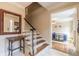 Inviting entryway featuring a staircase, a decorative mirror, and a glimpse into the adjacent living space at 5581 Stapleton Dr, Dunwoody, GA 30338