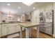 Bright kitchen with granite countertops, stainless fridge, and island with seating at 5581 Stapleton Dr, Dunwoody, GA 30338