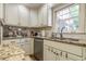 Close up of the kitchen area features stainless steel appliances and stone countertops at 5581 Stapleton Dr, Dunwoody, GA 30338