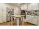 Well-equipped kitchen with stainless steel refrigerator and double oven built into custom cabinetry at 5581 Stapleton Dr, Dunwoody, GA 30338