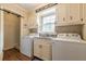Laundry room with washer, dryer, sink, cabinets and rustic decor at 5581 Stapleton Dr, Dunwoody, GA 30338
