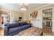 Comfortable living room featuring a cozy blue sofa, rustic coffee table, and a view into the bright kitchen at 5581 Stapleton Dr, Dunwoody, GA 30338