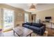 Bright living room featuring natural light, classic shutters, and a comfortable sofa with a vintage-style rug at 5581 Stapleton Dr, Dunwoody, GA 30338