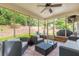 Screened patio with furniture overlooking lawn and trees at 5581 Stapleton Dr, Dunwoody, GA 30338