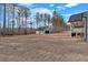 Spacious backyard with lush greenery, a detached garage, and a well-manicured lawn at 598 Barnwood Dr, Rockmart, GA 30153
