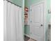 Bathroom featuring a white shower curtain and a built-in shelving unit for linens at 598 Barnwood Dr, Rockmart, GA 30153
