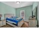 Cozy bedroom with a bed, dresser, nightstand, and a large window at 598 Barnwood Dr, Rockmart, GA 30153