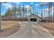 Scenic driveway leading to a detached garage surrounded by mature trees and lush landscape at 598 Barnwood Dr, Rockmart, GA 30153