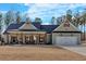 Inviting single-story home featuring a covered front porch, two-car garage, and a well-maintained lawn at 598 Barnwood Dr, Rockmart, GA 30153