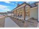 Charming covered porch features outdoor seating, wood columns, and a cozy ambiance with lovely wood shutters at 598 Barnwood Dr, Rockmart, GA 30153