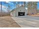 View of the detached two-car garage with long driveway in a wooded lot at 598 Barnwood Dr, Rockmart, GA 30153
