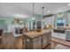 This kitchen features an island, stainless steel appliances, and an open view to dining space at 598 Barnwood Dr, Rockmart, GA 30153