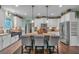 Spacious kitchen featuring white cabinetry, stainless appliances, and an island with pendant lighting at 598 Barnwood Dr, Rockmart, GA 30153