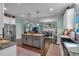 This kitchen includes an island, stainless steel refrigerator, and an open view to living spaces at 598 Barnwood Dr, Rockmart, GA 30153