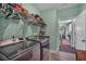 Modern laundry room featuring stainless steel appliances and ample storage shelving at 598 Barnwood Dr, Rockmart, GA 30153