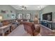 Spacious living room features a large sectional sofa, wood floors, and a ceiling fan at 598 Barnwood Dr, Rockmart, GA 30153