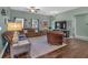 This living room features hard wood floors, a ceiling fan and a comfortable brown leather chair at 598 Barnwood Dr, Rockmart, GA 30153