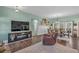 Open-concept living room with modern entertainment center and a dining area with lots of natural light at 598 Barnwood Dr, Rockmart, GA 30153