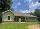 Back exterior showcasing the well-maintained lawn at 10390 Rivertown Rd, Fairburn, GA 30213