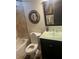 Bathroom featuring a tiled shower, toilet, and stylish vanity with a green countertop at 10390 Rivertown Rd, Fairburn, GA 30213