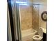 Bathroom with tiled shower and vanity, offering a functional and well-maintained space at 10390 Rivertown Rd, Fairburn, GA 30213
