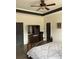This bedroom features a ceiling fan, fireplace, and television at 10390 Rivertown Rd, Chattahoochee Hills, GA 30213