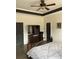 Cozy bedroom featuring a ceiling fan, dark trim, and a fireplace, offering a comfortable retreat at 10390 Rivertown Rd, Fairburn, GA 30213