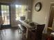 Dining area featuring rustic wooden table and bench under a chandelier near large windows at 10390 Rivertown Rd, Fairburn, GA 30213