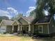 Beautiful home exterior with well-manicured lawn and attached garage at 10390 Rivertown Rd, Fairburn, GA 30213
