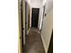 Hallway featuring dark hardwood floors and stylish dark-colored doors, creating a sleek and modern aesthetic at 10390 Rivertown Rd, Fairburn, GA 30213