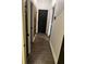 Hallway has dark hardwood floors and access to additional rooms at 10390 Rivertown Rd, Fairburn, GA 30213