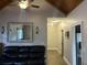 Living room with wood ceiling, gray walls, and a black leather sofa at 10390 Rivertown Rd, Fairburn, GA 30213