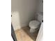 Small, tile-floored water closet featuring a standard toilet with white walls at 10390 Rivertown Rd, Fairburn, GA 30213