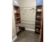 The walk-in closet has built-in shelving, rods, and wood flooring at 10390 Rivertown Rd, Chattahoochee Hills, GA 30213