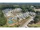 An aerial view of a residential community with lush greenery, sidewalks, and community pool and tennis courts at 108 Redford Ln, Canton, GA 30115