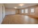 Unfinished basement with hardwood flooring, neutral walls, and large windows at 108 Redford Ln, Canton, GA 30115