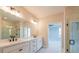 Stylish bathroom featuring dual sinks, a large mirror, and a glass-enclosed shower with modern fixtures at 108 Redford Ln, Canton, GA 30115