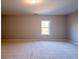 Spacious bedroom with neutral carpet and a window offering natural light at 108 Redford Ln, Canton, GA 30115