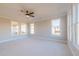 Bright bedroom featuring plush carpeting, a ceiling fan, and large windows offering plenty of natural light at 108 Redford Ln, Canton, GA 30115