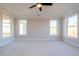Inviting bedroom featuring soft carpeting, a ceiling fan, and large windows providing ample natural light at 108 Redford Ln, Canton, GA 30115