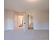 Bright, carpeted bedroom featuring an en-suite bathroom with modern doors for easy access at 108 Redford Ln, Canton, GA 30115